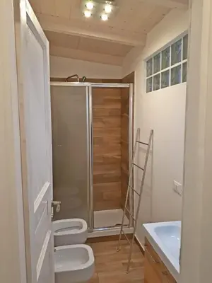 a bathroom with two toilets and a shower at Mondello Sicily House in Mondello