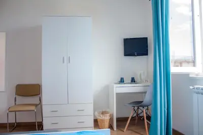 a living room with a desk and two chairs at Mondello Sicily House in Mondello