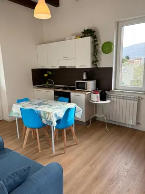 a kitchen and a table and chairs in a room at Mondello Sicily House in Mondello
