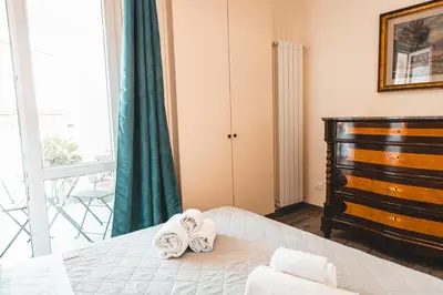 a bedroom with a bed with two towels on it at Attico 261 - Penthouse in Palermo