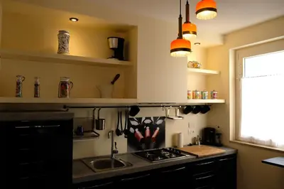 a kitchen with a sink and a stove top oven at Attico 261 - Penthouse in Palermo