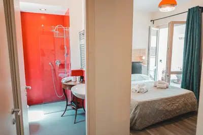 a bathroom with a bed and a sink and a shower at Attico 261 - Penthouse in Palermo