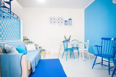 a blue living room with a blue couch and chairs at Blue Suite in Castellammare del Golfo