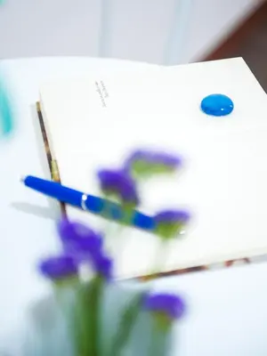 a close up of some pens and purple flowers at Blue Suite in Castellammare del Golfo