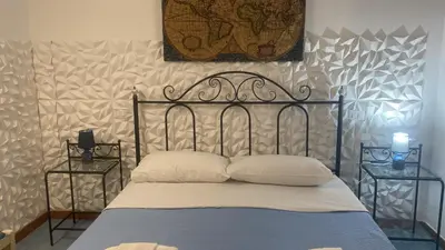 a bed with two pillows on it in a bedroom at Hellas Makari B&B in San Vito lo Capo