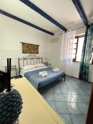 a bedroom with a bed with two towels on it at Hellas Makari B&B in San Vito lo Capo