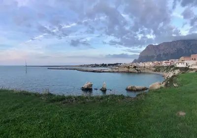 a large body of water with rocks in the water at Alma Nua in Terrasini