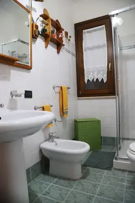 a bathroom with a sink and a toilet and a shower at Lucy's cottage in Cinisi