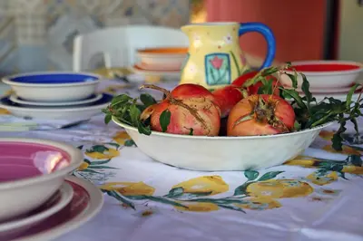 a bowl of pomegranates sitting on a table at Lucy's cottage in Cinisi
