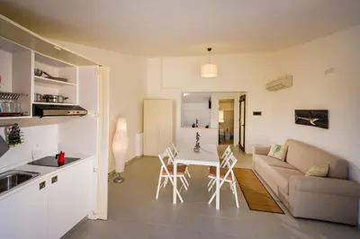 a kitchen and living room with a couch and a table at N'amuri Residence in Castellammare del Golfo