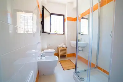 a bathroom with a toilet and a sink and a shower at N'amuri Residence in Castellammare del Golfo