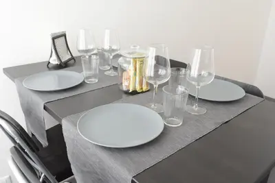 a kitchen with white appliances and a table with yellow chairs at Caselita in Palermo