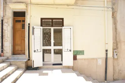 an open door on a building with stairs at Aura Maris in Castellammare del Golfo