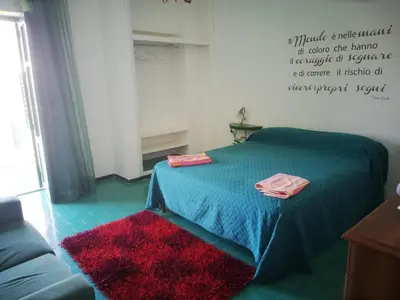 a room with a bed with two towels on it at Villa Buonasera in Santa Flavia