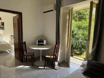 a room with a table with a microwave on it at Apartment Co in Palermo
