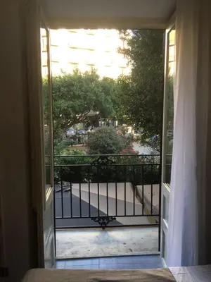 an open door to a balcony with a view of a yard at Apartment Co in Palermo