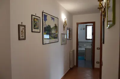 a hallway with pictures on the walls of a house at Villa Matilde in Carini