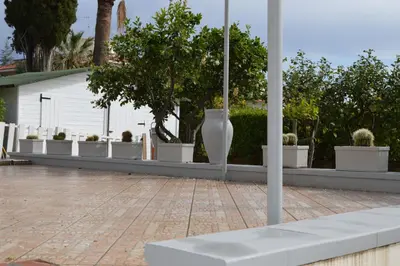 a row of white vases sitting next to a building at Villa Matilde in Carini