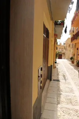 an empty alley with a building and a street at Casa Trio Apartments in Castellammare del Golfo