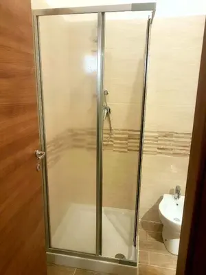 a shower stall in a bathroom with a toilet at Casa Trio Apartments in Castellammare del Golfo