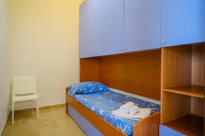 a bedroom with a bed with two towels on it at La Casa delle Ginestre in Alcamo Marina
