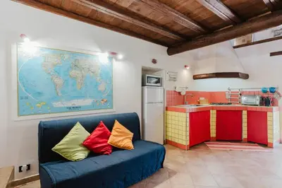 a living room with a blue couch with colorful pillows at Villa 'Antico Baglio' - Scopello - Castellammare Del Golfo in Castellammare del Golfo
