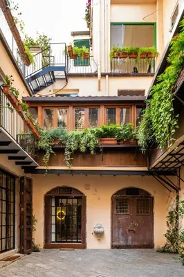 an apartment building with plants on the balconies at Le Stanze al Genio di Darlon in Palermo