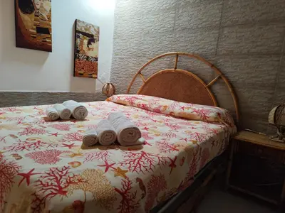 a bed with three rolled towels on top of it at La Marina in Castellammare del Golfo