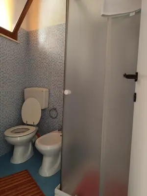 a bathroom with a toilet and a sink at La Marina in Castellammare del Golfo