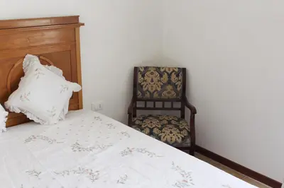 a bedroom with a bed and a chair at Palazzo Taormina in Castellammare del Golfo