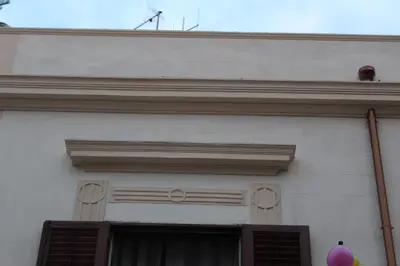 a white building with a window and a roof at Palazzo Taormina in Castellammare del Golfo