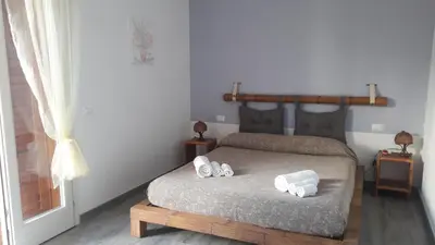 a bedroom with a bed with two towels on it at Il Bambu' in San Vito lo Capo