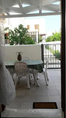 a table and chairs sitting on a balcony at Il Bambu' in San Vito lo Capo