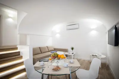 a living room with a table and a couch at Politeama Apartments by Giorgio in Palermo