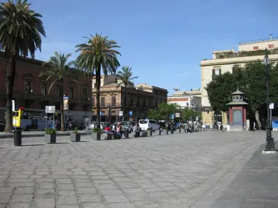 a city street with palm trees and buildings at Casa Nonna Toto in Palermo