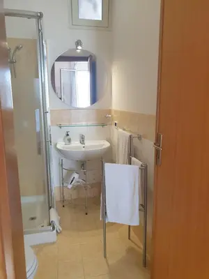 a bathroom with a sink and a mirror at Le Casette in Santa Flavia