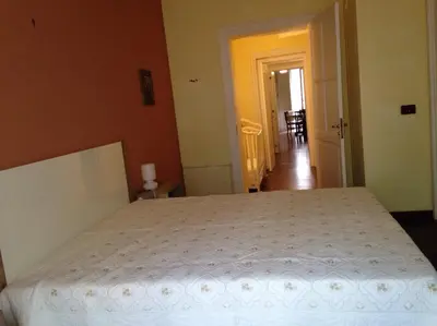 a bedroom with a bed with a white bedspread at La Casa Di Tufo in Palermo