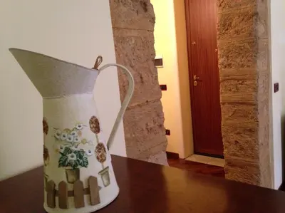 a vase sitting on top of a table at La Casa Di Tufo in Palermo