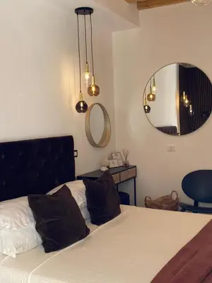a bedroom with a large bed and a mirror at Atrium in Castellammare del Golfo
