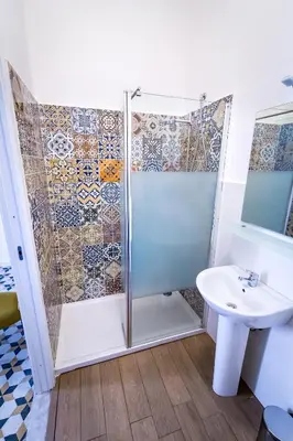 a bathroom with a shower and a sink at Liberty Suites in Palermo