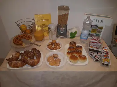 a table topped with plates of pastries and drinks at B&B Ponticello in Palermo