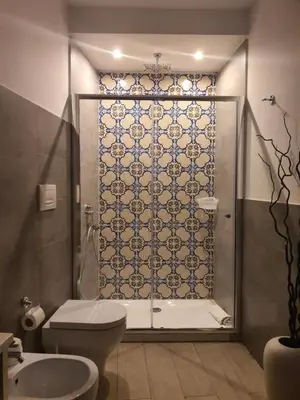 a bathroom with a shower with a toilet and a sink at B&B Ponticello in Palermo