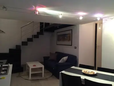 a living room with a blue couch and a staircase at Corsovittorio111 in Palermo