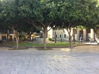 a group of trees in front of a building at Corsovittorio111 in Palermo