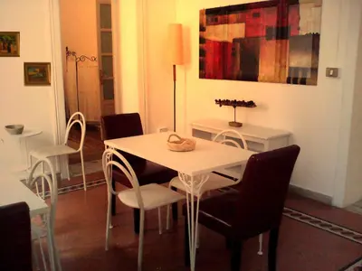 a dining room with a white table and chairs at Palermo Centrale in Palermo