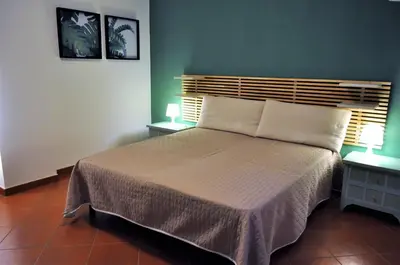 a bedroom with a large bed and two night stands at casa Francy in San Vito lo Capo