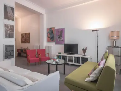 a living room with a couch and a tv at Casa Rosa in Palermo