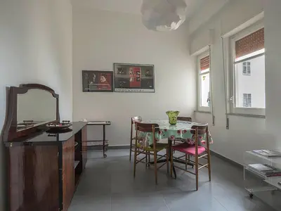 a room with a table and chairs and a mirror at Casa Rosa in Palermo
