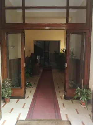 an open door of a building with potted plants at Casa Rosa in Palermo
