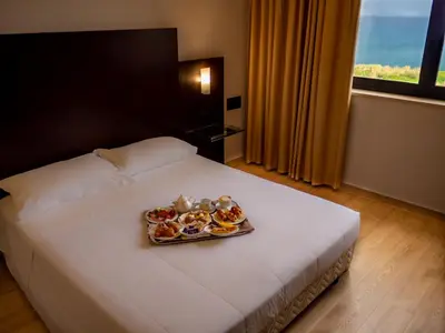 a hotel room with a tray of cupcakes on a bed at San Paolo Palace Hotel in Palermo
